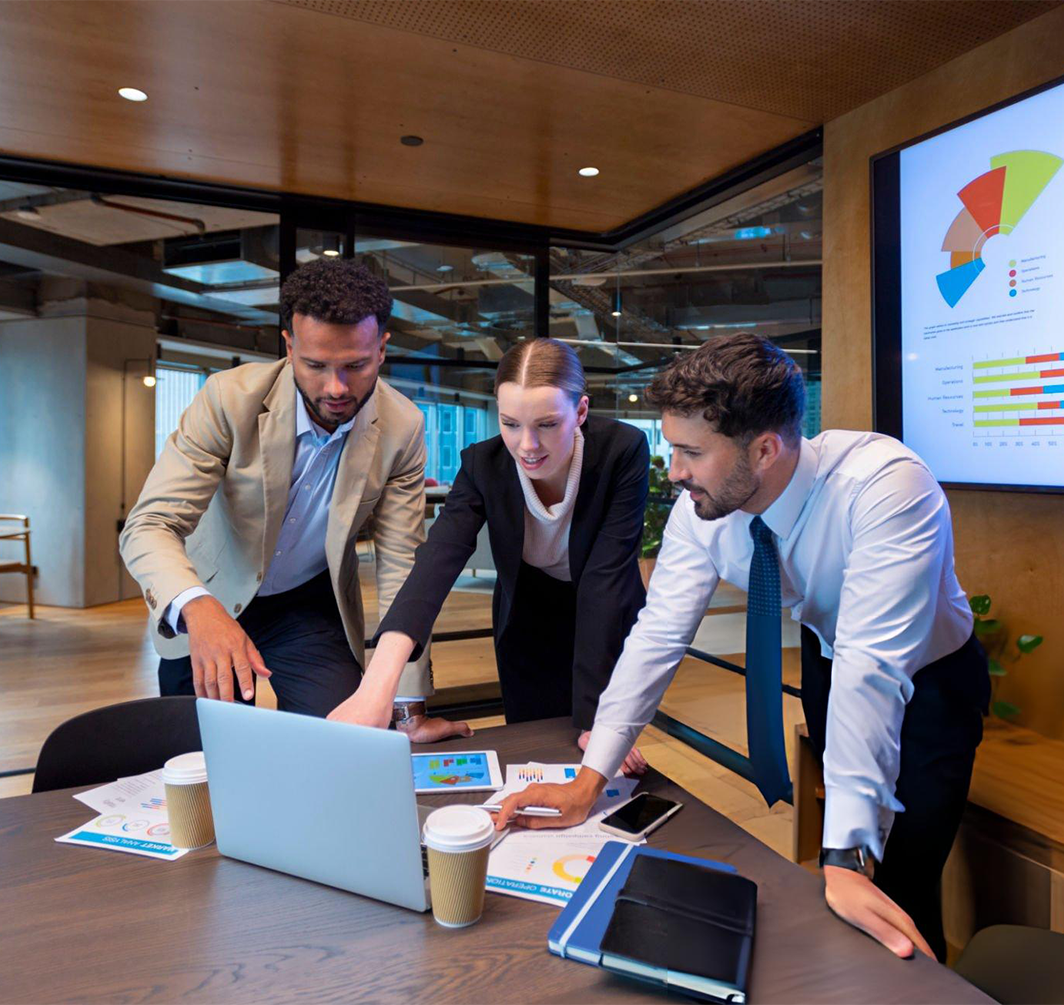 three people pointing at a computer