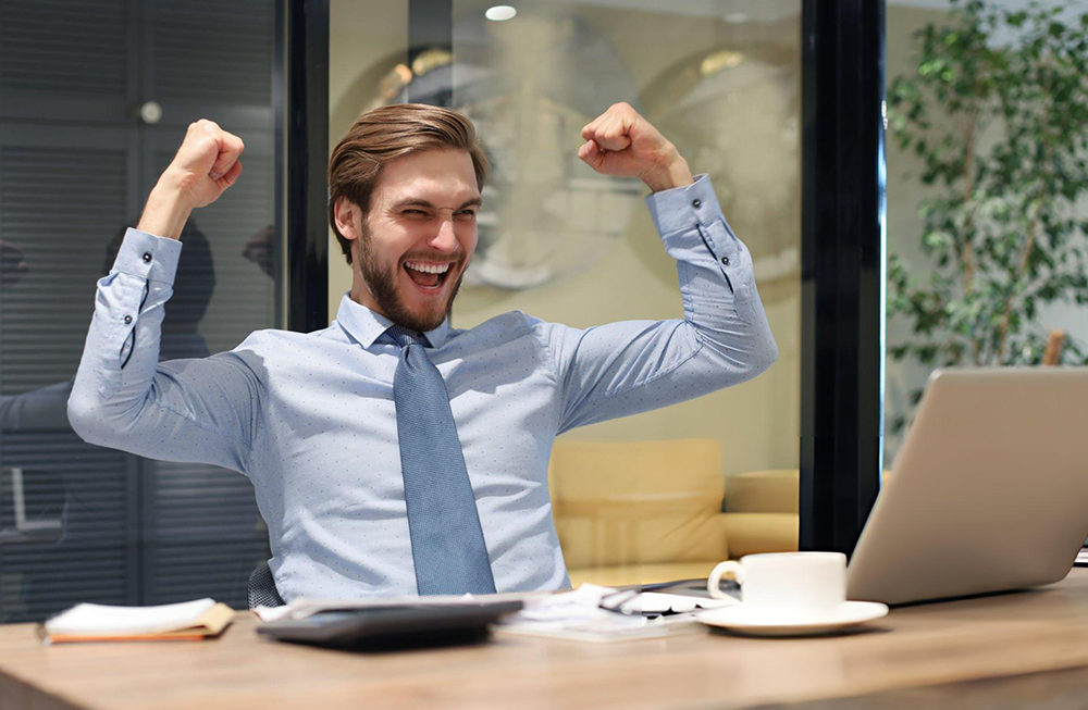 man flexing and celebrating in the office