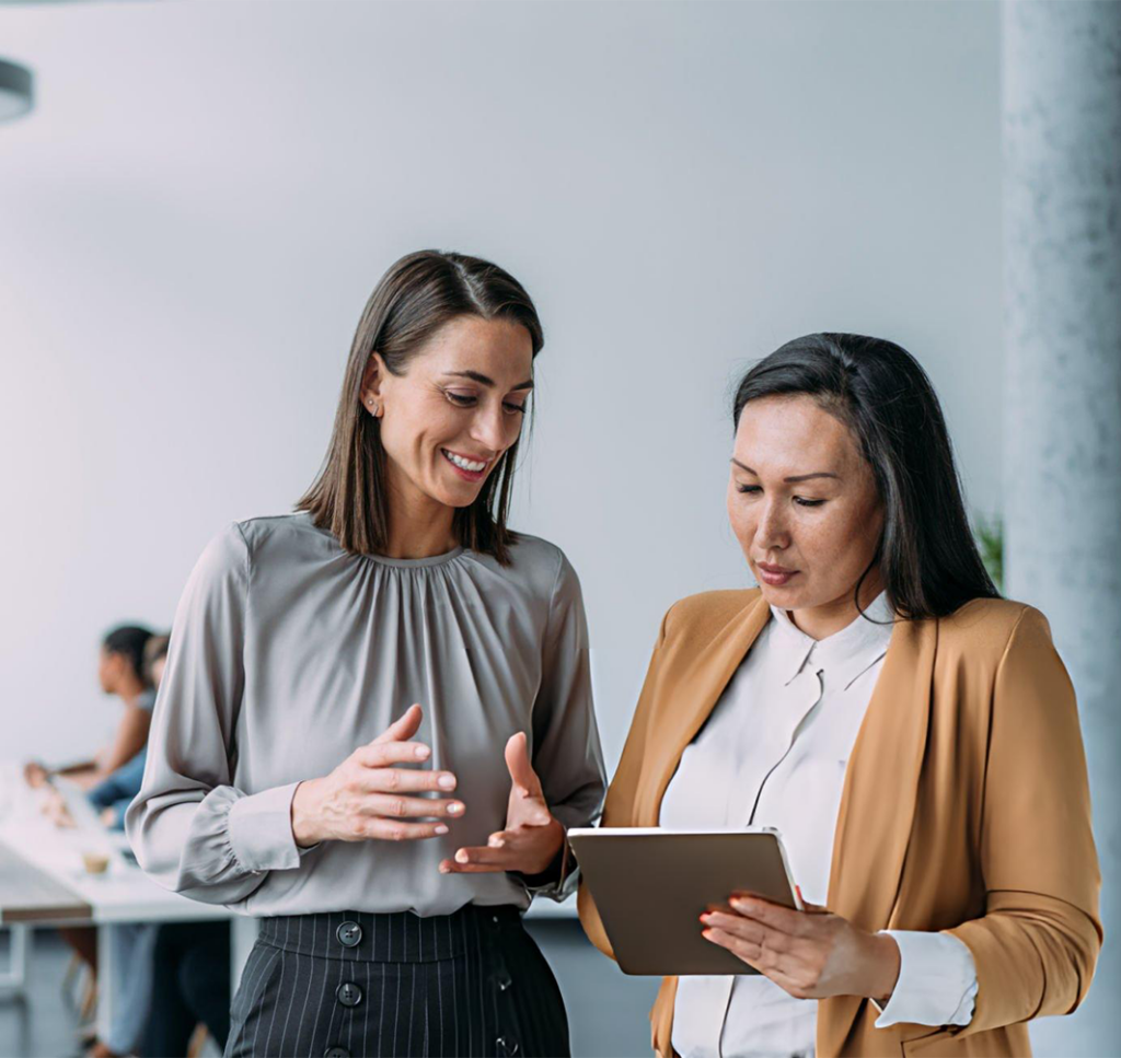 two women looking at a tablet